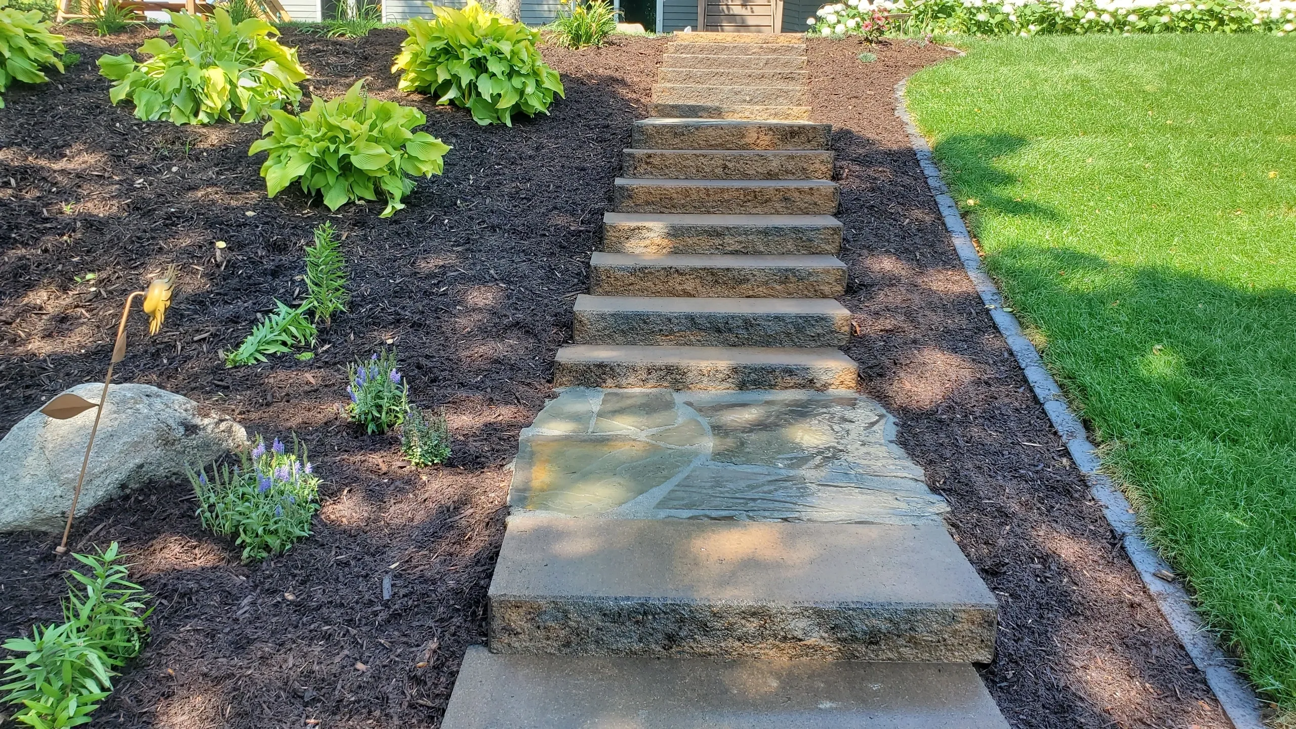 A walkway with steps leading to the ground.