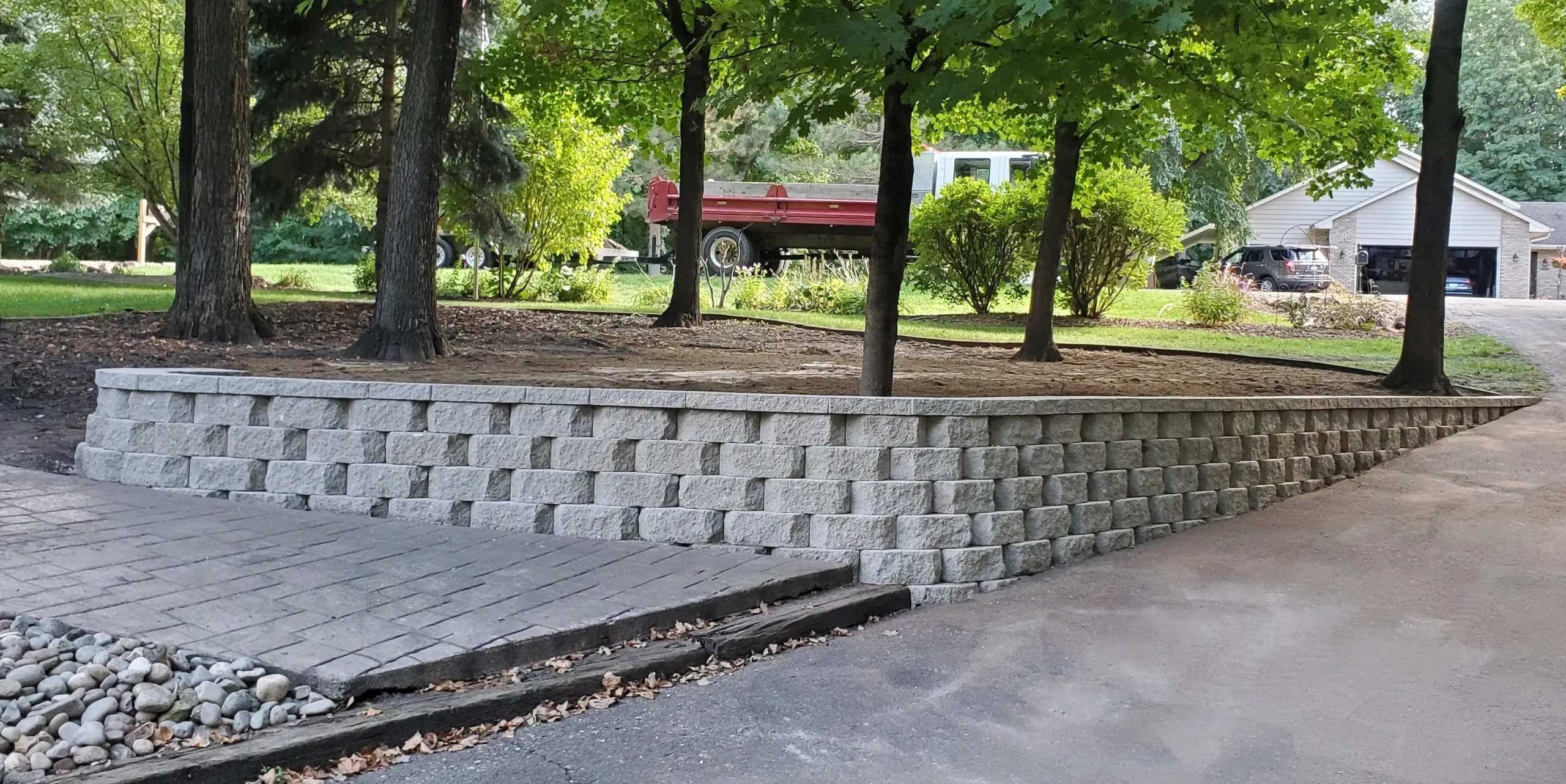 A concrete block wall in the middle of a park.