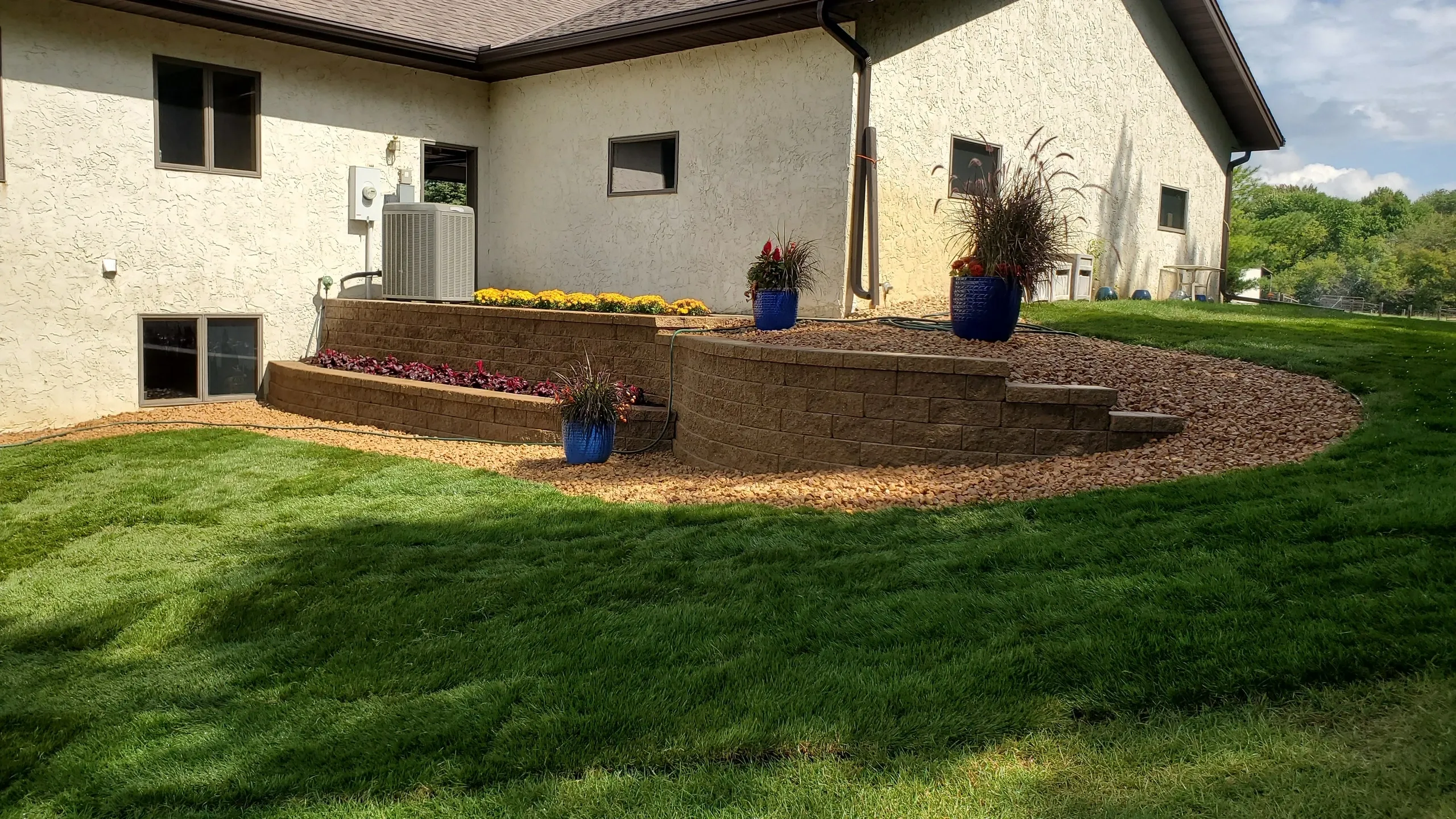 A house with a lawn and flowers in the yard.